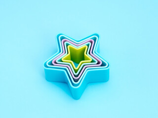 Baking dish star on the blue background. Pastel background