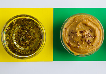 Dijon mustard and olive sauce on a bright green and yellow background