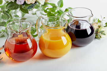 Jugs with different juices on event catering. Apple, orange, cherry and tomato juices