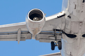 Jet engine and landing gear flying in the air.