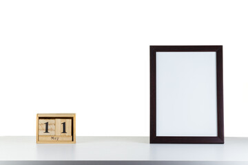 Wooden calendar 11 may with frame for photo on white table and background