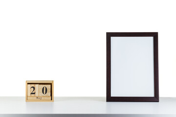 Wooden calendar 20 may with frame for photo on white table and background