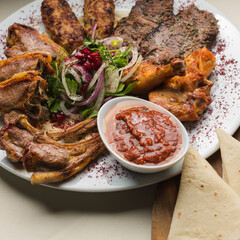 Turkish and Arabic Traditional Kebab plate. Freshly cooked meat in a restaurant. Online course recipe for making a delicious meal.