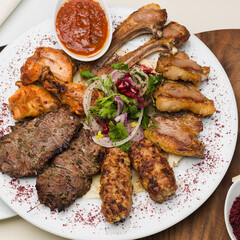 Turkish and Arabic Traditional Kebab plate. Freshly cooked meat in a restaurant. Online course recipe for making a delicious meal.