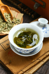 Lotus leaf tea in blue and white porcelain covered bowl