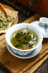 Lotus leaf tea in blue and white porcelain covered bowl