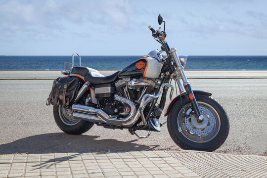 BARCELONA, SPAIN-FEBRUARY 11, 2021: Harley-Davidson motorcycle, parked next to sea