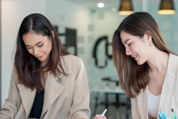 Young Asian businesswoman happy working at the office.