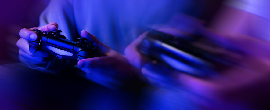 Gamers Playing Console Video Games. Controller In Hands Closeup. Neon Lights Banner