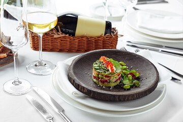 Salad of avokado, seafood, meat, vegetables and pumpkin seeds. Dietary, wholesome and tasty. Banquet festive dishes. Gourmet restaurant menu. White background.