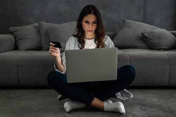 Upset confused woman sitting on couch