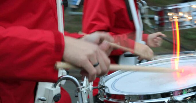 drummer of a marching band with glowing drum sticks and snare