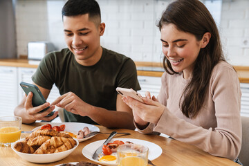 Portrait of smiling couple using smartphones