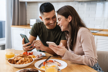 Portrait of smiling couple using smartphones