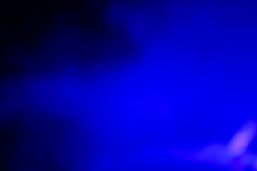 Blurred dark background with blue smoke light.