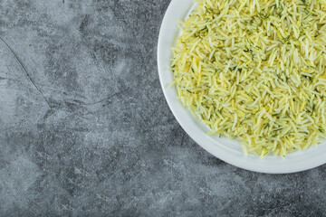 Plate of delicious rice on marble background