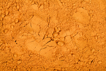 yellow curcuma (curcuma longa) or turmeric powder background. top view. spice and medicinal herb concept