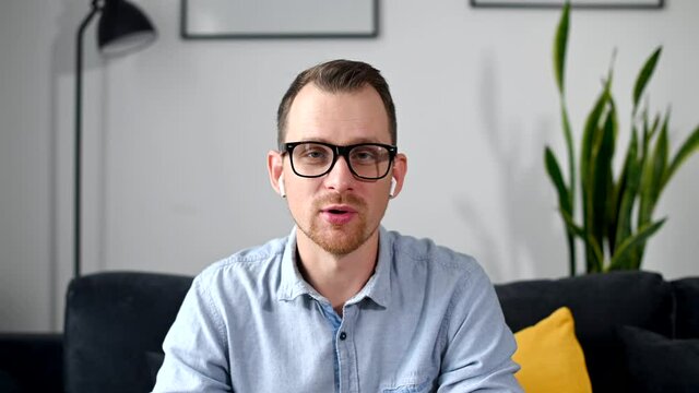 An intelligent man talking online and looks at webcam, has conference business call. Webcam view a confident applicant speaking on online interview. Video call with smart coach