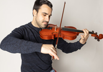young man playing violin on the white background