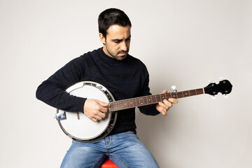 young man playing banjo on the white background