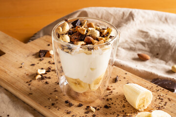 yogurt cup with banana, chocolate chips and dried fruit