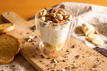 yogurt cup with banana, chocolate chips and dried fruit