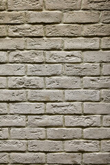 Textured beige brick wall, stone texture. decorative tiles for wall decoration. Background,  beige decorative brick. loft decor style. structural surface, imitates old brick
