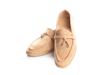Pair of beige modern unisex loafers on white background