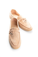 Pair of beige modern unisex loafers on white background