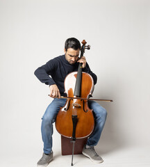 young man playing cello on the white background