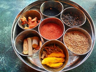Various dry spices and Raw herbs in small bowls (Anjaraipetti). Indian traditional things