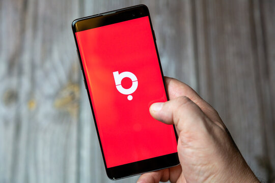 02-24-2021 Portsmouth, Hampshire, UK A mobile phone or cell phone being held by a hand with the Baaz app open on screen