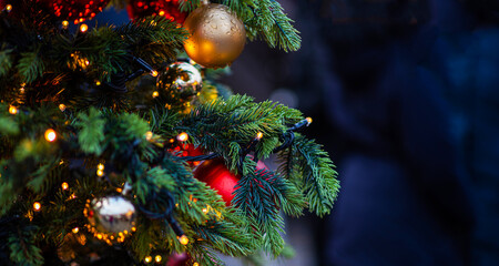 Decorated Christmas tree on blurred background. New Year's and Christmas holiday background with lights on tree.