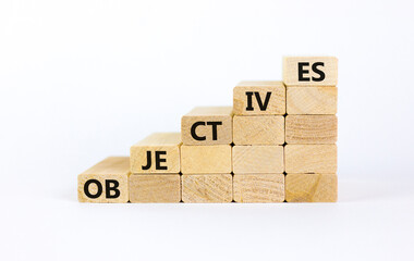 Objectives symbol. Wooden blocks stacking as step stair on white background, copy space. Word 'objectives'. Business and objectives concept.