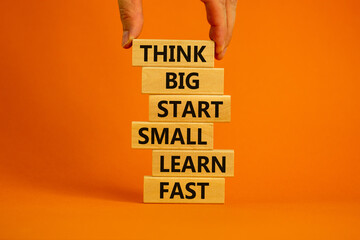 Think big start small symbol. Words 'Think big start small learn fast' on wooden blocks on a...
