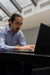 Fototapeta na wymiar vertical photo of a man using computer in office. freelancing