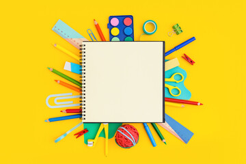 Notebook page and school supplies. Creative flat lay desk