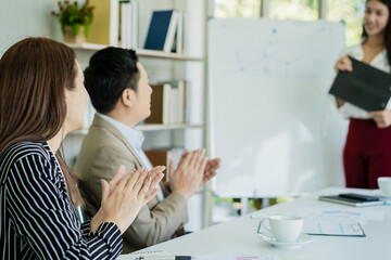 Obraz premium Cheer up, Start up business people group, teamwork of young asian clap, having fun,happy in workplace after project is done, win while meeting with partner, team on board. Celebrating success concept.