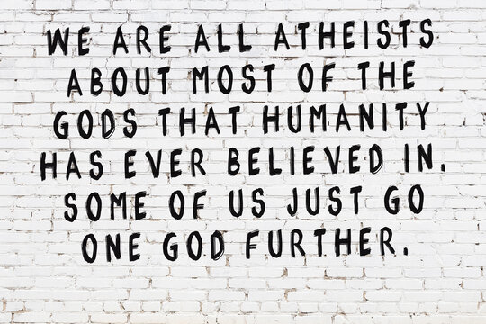 Painted black mindful inscription on white brick wall background