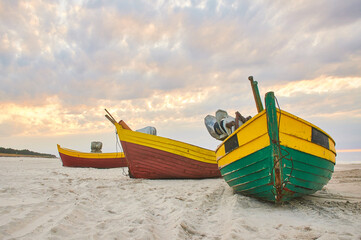 fishing boats on the sandy Baltic beach on a sunny summer day