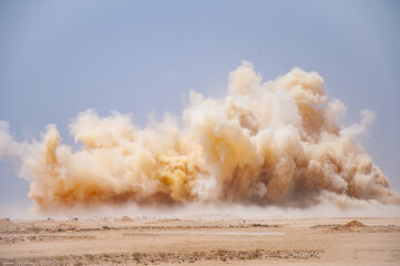 Dust storm during detonator blast in the desert  - obrazy, fototapety, plakaty