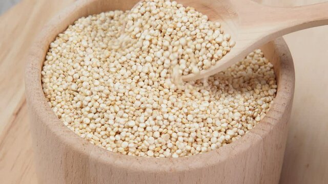 quinoa in bowl kitchen table. Healthy and diet superfood product.