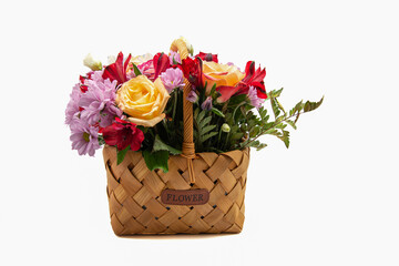 Bouquet of flowers in a basket on a white background