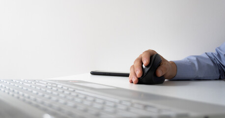 panoramic photo of a man using a vertical mouse