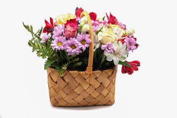 Bouquet of flowers in a basket on a white background