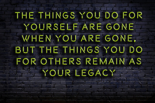 Wise quote. Neon inscription against brick wall