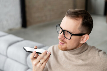 Close up of handsome married bearded hipster man entrepreneur businessman in glasses holding mobile...