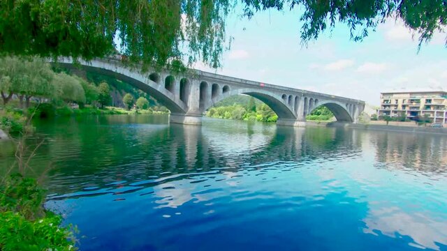 Pont du Chemin de Fer, railway bridge at Huy on a sunny summer day, above The Maas, Huy, Belgium, 4k, 50fps