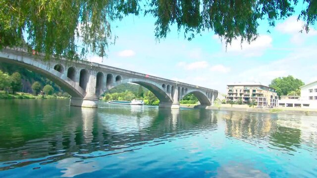 Pont du Chemin de Fer, railway bridge at Huy on a summer day with a barge, The Maas in Huy, Belgium, 4k, 50fps