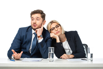 tired blonde news presenter leaning on bored colleague at workplace isolated on white